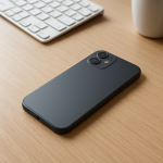 Smartphone face down on clean desk, charger nearby, low light