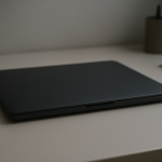 Laptop Battery Draining While Lid Closed — Sleep Mode Failure Causes Closed laptop on tidy desk with faint battery glow