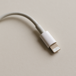 Bent charging cable resting on a tidy wooden desk